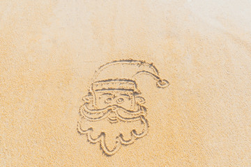 Concept Christmas on the beach Tropical design made in Phuket, Thailand Write the alphabet on the sand background Taken from real locations.