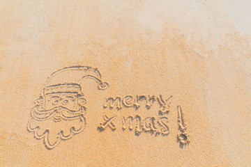 Concept Christmas on the beach Tropical design made in Phuket, Thailand Write the alphabet on the sand background Taken from real locations.