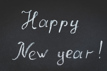Obraz premium with the new year, the inscription on the blackboard, toning and vignetting