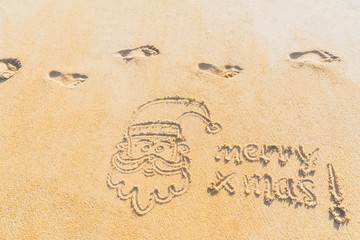 Concept Christmas on the beach Tropical design made in Phuket, Thailand Write the alphabet on the sand background Taken from real locations.