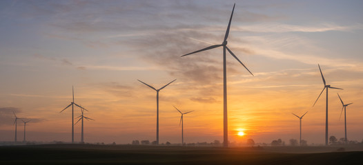 windmills on the field during a beautiful sunrise