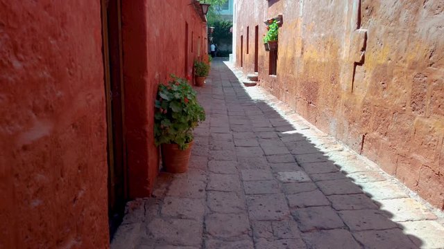 Narrow streets and deep red walls around Saint Catherine's Monastery (Convento de Santa Catalina), Arequipa city, Peru