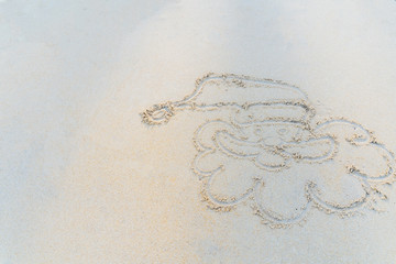Concept Christmas on the beach Tropical design made in Phuket, Thailand Write the alphabet on the sand background Taken from real locations.
