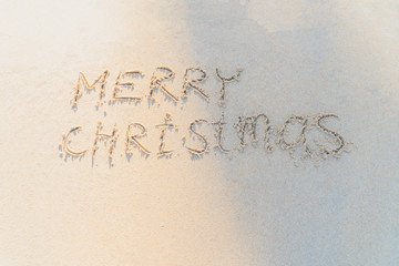 Concept Christmas on the beach Tropical design made in Phuket, Thailand Write the alphabet on the sand background Taken from real locations.