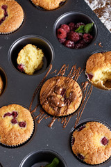 The process of baking delicious muffins with berries, white cream, chocolate.