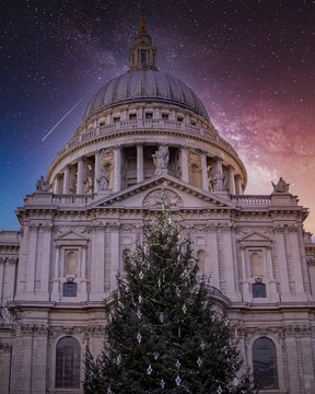 Christmas tree in front of St Paul's cathedral under starry night sky, London UK