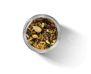 Green tea with aromatic additives. Top view on white background