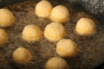 balls of cheese in breadcrumbs fried in oil
