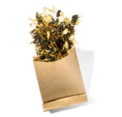 Green tea with aromatic additives. Top view on white background