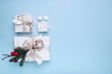 Christmas background. Gifts with Christmas decor in white boxes on a blue background. Minimalism, Flat lay, top view, copy space