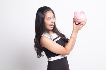 Fototapeta na wymiar Young Asian woman with a pig coin bank