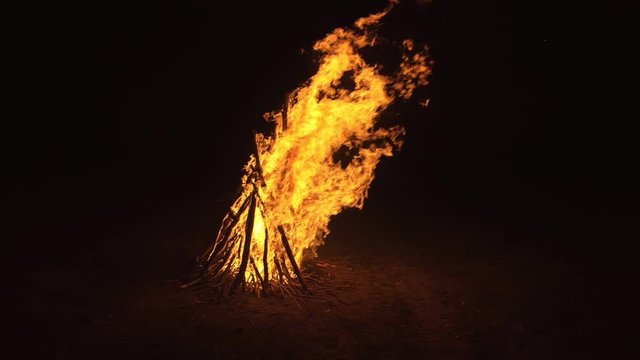 Silhouette of mystic woman in black background of fire fly flame, spark, of contour outline. Adult sexy of young girl witchcraft ceremony ritual dance in underclothes. Outdoor slow motion. Caucasian.