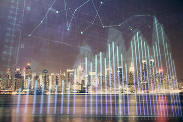 Financial graph on night city scape with tall buildings background multi exposure. Analysis concept.