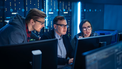 Three IT Engineers / Programmers Talking about Work, Using Computers. Technical Department with...