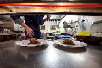 fancy food being plated in commercial kitchen