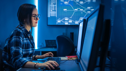 Smart Female IT Engineer / Programer Working on Desktop Comuter. Software Development / Coding/ Web Design / Database Architecture. Young Girl STEM Graduate Working