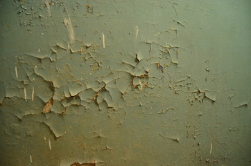 old painted wall with peeling blue paint