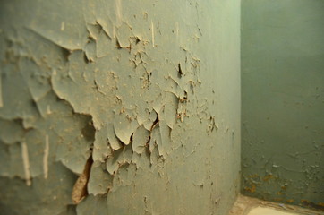 peeling blue paint on the wall