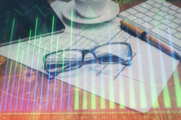 Financial chart hologram with glasses on the table background. Concept of business. Double exposure.
