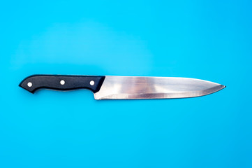 Large knife on blue background