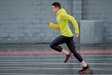 sprinter running fast from right to left on some running tracks