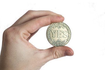 Coin Yes in a palm on a white background