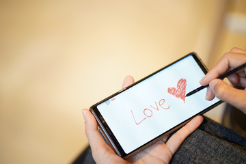 Writing heart for valentine greetings through mobile phone technology using current people's applications