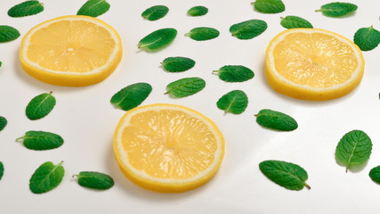 Mint leaves am lemon slices on white background