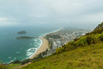 ニュージーランド　タウンランガ湾の半島にあるマウント・マウンガヌイのマウアオの丘の麓から見えるビーチと街並み