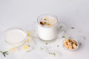lassi next to the ingredients on a white background