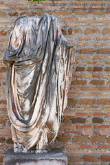 antique marble headless sculpture in the ancient Italian city of Antica Ostia