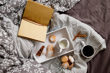 cozy flat ley in scandinavian style. Coffee with cookies in bed. 