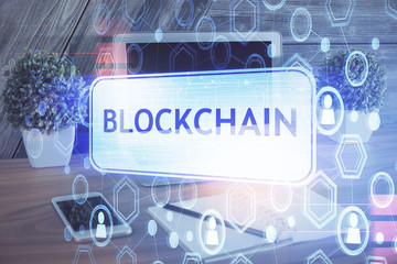 Double exposure of blockchain theme hologram and table with computer background. Concept of bitcoin...