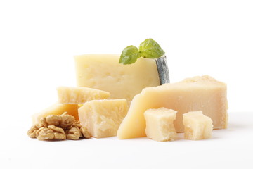 Parmesan slice with walnuts and basil isolated on white background