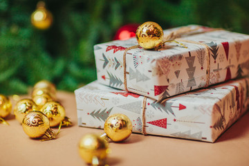 Christmas composition. Christmas gift, fir branches on carton background. Flat lay, top view, copy space. White christmas gifts and ornaments.
