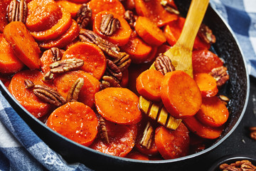 Candied sweet potatoes with pecan nuts, closeup
