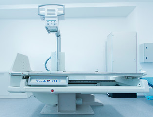 Modern medical room with automatic X-ray machine and couch