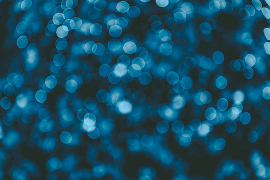 Blue abstract shimmering bokeh background with shining lights