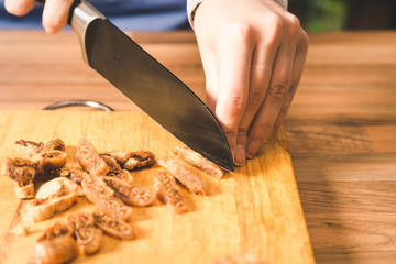 Close-up of woman cutting dried figs.