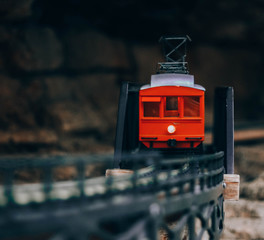 A red train on the side of a cliff