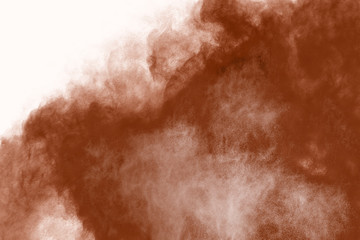 Brown color powder explosion on white background. 