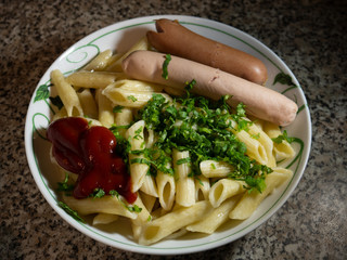 dinner, pasta and sausages are in the plate