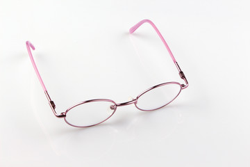Pink eye glasses spectacles on white background. for reading daily life to a person with visual impairment.