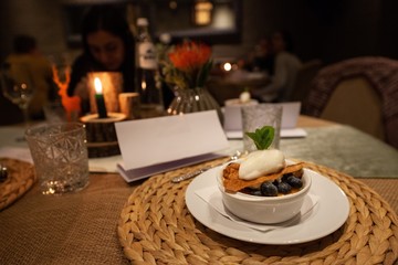 Fototapeta na wymiar creme brulee with blueberries and ice cream on table in fancy restaurant