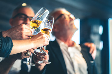 Group of business people toasting champagne glasses for the celebration of successful business.