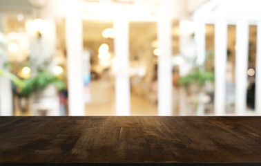 Empty dark wooden table in front of abstract blurred bokeh background of restaurant . can be used for display or montage your products.Mock up for space.