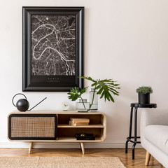 Interior design of living room at nice scandinavian apartment with stylish commode, tropical plant, books and elegant accessories. Modern home decor. Template. Mock up poster map. Home staging.