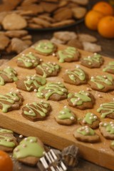Christmas homemade gingerbread cookie sprinkled with green sugar on a wooden board