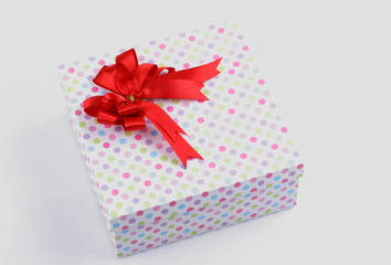 colorful polka dots box with ribbon on white background,with clipping path.