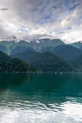 Summer landscape alpine lake and mountains with cloudy sky. Lake Ritsa. Abkhazia